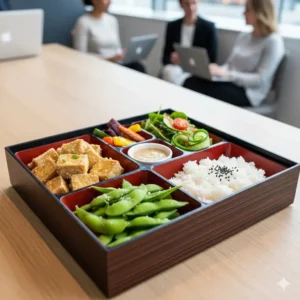 A colorful, appealing vegetarian corporate bento box option with tofu, edamame, and a variety of fresh produce.