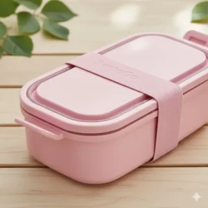 Close-up showing the secure, leakproof seal and durable closure straps of the pink bento lunch box.