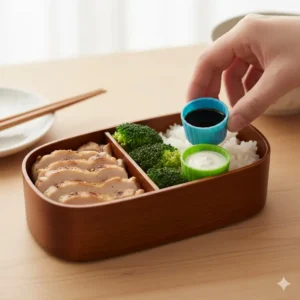 Small, leakproof sauce containers acting as effective bento dividers to keep dressings and dips from mixing with the main ingredients.