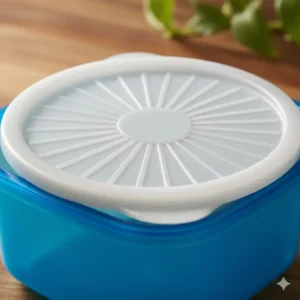 Close-up detail of the iconic tupperware heritage blue sunburst lid design showing the easy-seal center.